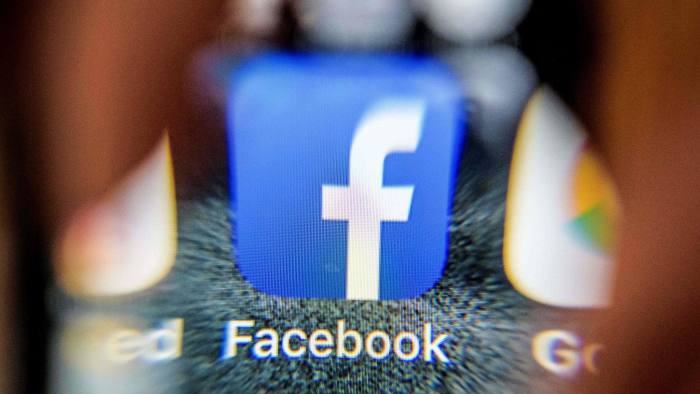 An illustration picture taken through a magnifying glass on March 28, 2018 in Moscow shows the icon for the social networking app Facebook on a smart phone screen. Facebook said on March 28, 2018 it would overhaul its privacy settings tools to put users "more in control" of their information on the social media website. The updates include improving ease of access to Facebook's user settings, a privacy shortcuts menu and tools to search for, download and delete personal data stored by Facebook. / AFP PHOTO / Mladen ANTONOVMLADEN ANTONOV/AFP/Getty Images