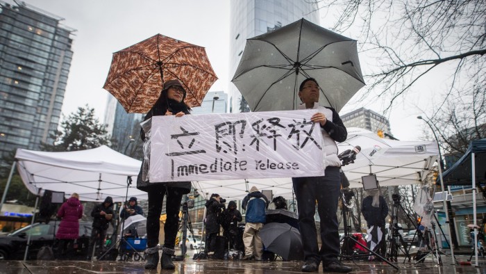 Meng Wanzhou's supporters held signs outside her bail hearing in Vancouver in December.