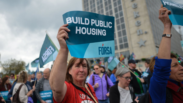 A protester seen with 'Build Public Housing' sign during a protest against the housing crisis 'Raise the Roof.&quot; On Saturday, May 18, 2019, in Dublin, Ireland. (Photo by Artur Widak/NurPhoto via Getty Images)