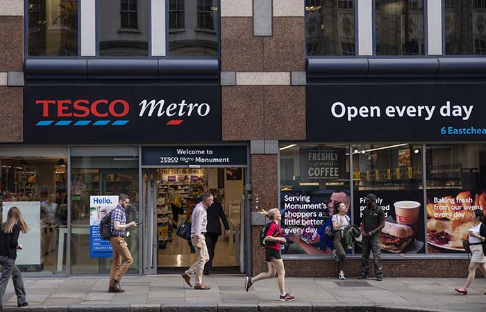 LONDON, ENGLAND - AUGUST 05: Members of the public walk past a Tesco Metro store on August 05, 2019 in London, England. The supermarket chain has announced it to cut around 4,500 members of staff, mostly from the 153 'Metro' stores across the UK.
