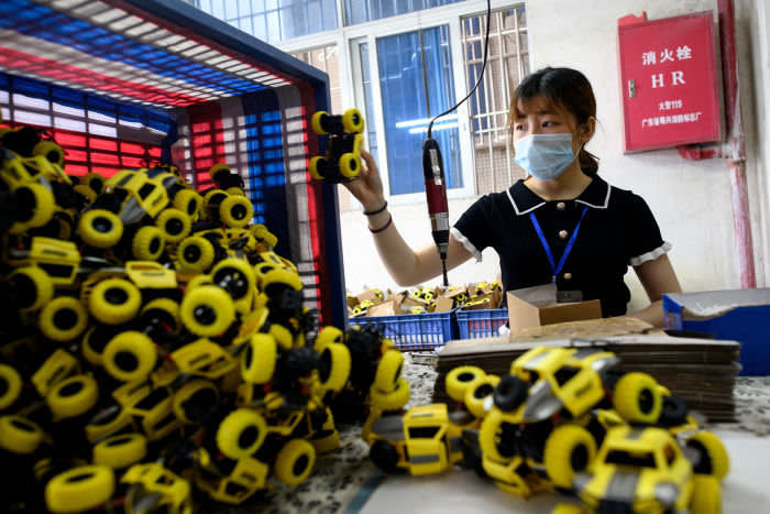 A worker wearing a face masks packages toy cars at the Mendiss toy factory in Shantou, southern China's Guangdong province on May 20, 2020. - Chinese factory activity continued to expand in April, data showed on April 30, but analysts warned that the outlook remained clouded by battered overseas demand as the rest of the world struggles to overcome the coronavirus pandemic. (Photo by NOEL CELIS / AFP) (Photo by NOEL CELIS/AFP via Getty Images)