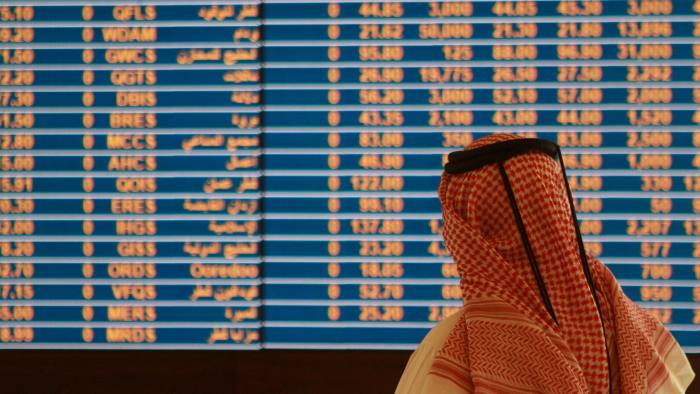 Trader watches an electronic share price display at the Doha Stock Exchange in Doha...A trader watches an electronic share price display at the Doha Stock Exchange in Doha May 28, 2015. Qatar's bourse fell in early trade on Thursday, extending losses following the launch of criminal investigations against senior FIFA officials, while stocks upgraded by index compiler MSCI supported markets in the United Arab Emirates. REUTERS/Naseem Zeitoon - RTX1EW7Z