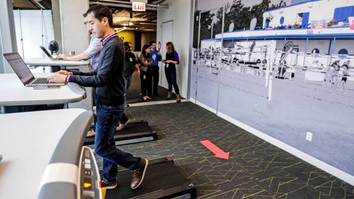Employees work at treadmill desks in the new Google Chicago Headquarters Thursday, Dec. 3, 2015, in Chicago. The new offices occupy about 200,000 square feet and house a staff of around 650 full time employees. (AP Photo/M. Spencer Green)