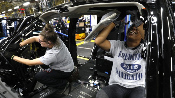 LOUISVILLE, KY - OCTOBER 27: Ford workers Jasmine Powers (right) and Cassie Bell (left), both of Louisville, Kentucky, install visors into the all-new 2018 Ford Expedition SUV as it goes through the assembly line at the Ford Kentucky Truck Plant October 27, 2017 in Louisville, Kentucky. Ford recently invested $900 million in the plant for upgrades to build the all-new Expedition and Lincoln Navigator, securing 1000 hourly U.S. jobs. (Photo by Bill Pugliano/Getty Images)