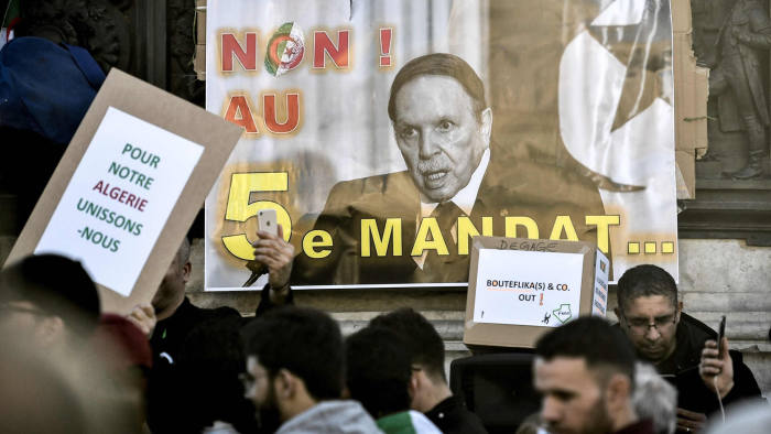 A sign with the image of the Algerian President and which reads, 'No to a 5th mandate' is placed at the base of a statue as protesters rally against the Algerian president's bid for a fifth term in office on February 24, 2019 at the Place de la Republique in Paris. - President Abdelaziz Bouteflika is Algeria's longest-serving president and a veteran of its independence struggle who has clung to power since 1999 despite his ill health. (Photo by STEPHANE DE SAKUTIN / AFP)STEPHANE DE SAKUTIN/AFP/Getty Images