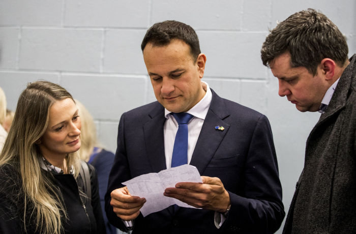 Taoiseach Leo Varadkar at Phibblestown Community Centre in Dublin with Emer Currie (left) and Ted Leddy (right) look a sheet of paper with the breakdown of votes, as counting continues in the 2020 Irish General Election count for the constituency of Dublin West. PA Photo. PA Photo. Picture date: Sunday February 9, 2020. See PA story IRISH Election. Photo credit should read: Liam McBurney/PA Wire