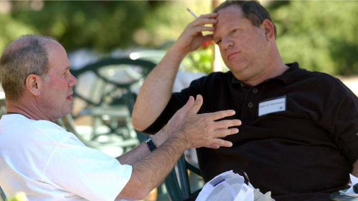 Walt Disney Co. CEO Michael D. Eisner, left, talks with Miramax Film Corp. Co-Chairman Harvey Weinstein on the grounds of the Sun Vally resort during the Allen & CO conference in Sun Valley, Idaho, Thursday, July 8, 2004. Photographer: Matthew Staver/Bloomberg News.