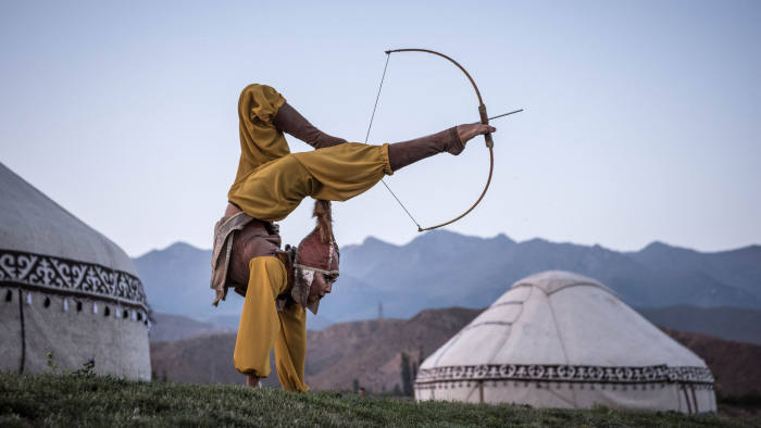 Aida Akmatova, a circus performer, shoots a bow and arrow with her feet at the World Nomad Games in Cholpon-ata, Kyrgyzstan, Sept. 4, 2018. Local participants reveled in the events; Akmatova also competed in horseback archery. "This is not just another performance, but a key event in my life," she said. "I can help pass down our culture, our traditions." (Sergey Ponomarev/The New York Times) Credit: New York Times / Redux / eyevine For further information please contact eyevine tel: +44 (0) 20 8709 8709 e-mail: info@eyevine.com www.eyevine.com