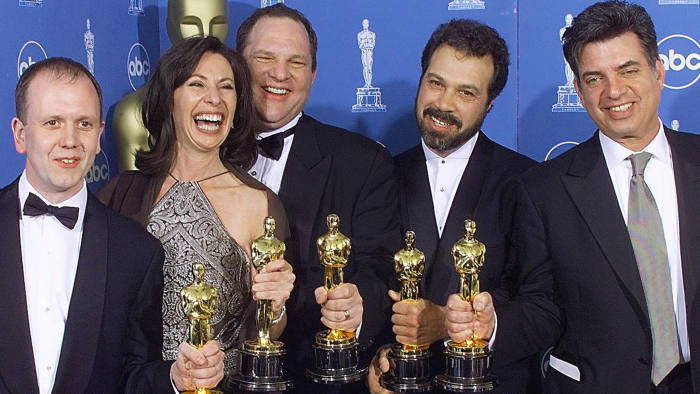 LOS ANGELES, UNITED STATES: Winners of the Oscar for Best Picture, "Shakespeare in Love", pose for photographers 21 March 1999 at the Dorothy Chandler Pavilion in Los Angeles during the 71st Annual Academy Awards. From left are: David Parfitt, Dianna Gigliotti, Harvey Weinstein, Edward Zwick, and Marc Morman. (ELECTRONIC IMAGE) (Photo credit should read HECTOR MATA/AFP/Getty Images)