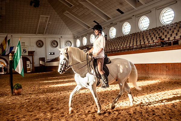 Ruth Bloomfield, FT editor, rides a horse during a training session with Master Juan Rubio at the Real Escuela Andaluza de Arte Ecuestre.