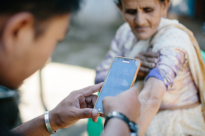 A woman in Nepal has her skin lesions scanned for leprosy using a smartphone