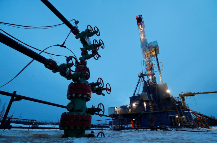 FILE PHOTO: A view shows a well head and a drilling rig in the Yarakta Oil Field, owned by Irkutsk Oil Company (INK), in Irkutsk Region, Russia March 11, 2019. Picture taken March 11, 2019. REUTERS/Vasily Fedosenko/File Photo