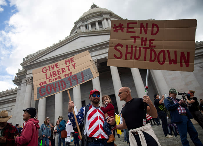 Demonstrators gather in Olympia, Washington to protest against the state’s stay-at-home orders. Trump adviser Stephen Moore says he told the president ‘this lockdown is causing more deaths and misery than the disease itself’
