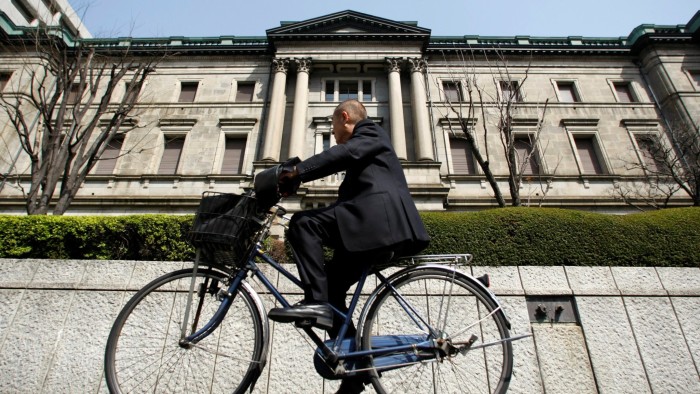 A man rides a bicycle past the Bank of Japan (BOJ) building in Tokyo March 18, 2009. REUTERS/Yuriko Nakao/File Photo