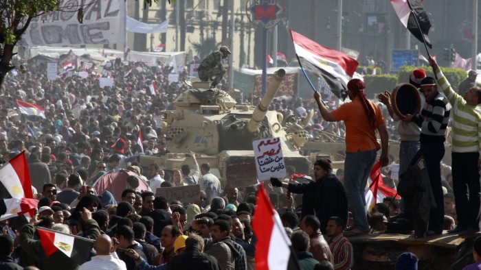 An Egyptian soldier atop a tank watches opposition supporters during a huge rally in the opposition stronghold in Tahrir Square in Cairo February 8, 2011. Egypt has a plan and timetable for the peaceful transfer of power, the vice president said on Tuesday, as protesters called more demonstrations to show their campaign to oust President Hosni Mubarak remains potent. REUTERS/Yannis Behrakis (EGYPT - Tags: CIVIL UNREST POLITICS MILITARY IMAGES OF THE DAY)