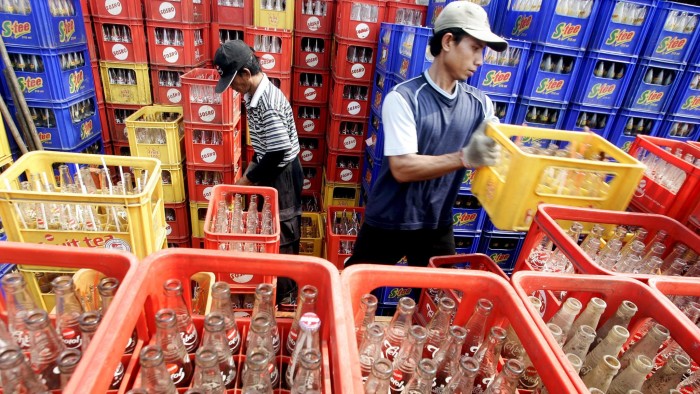 epa01385571 Workers arrange crates of soft drinks bottles at a distribution center in Jakarta, Indonesia, 17 June 2008. Indonesian central bank (BI) governor Boediono suggested price pressures were still building, forecasting that inflation could accelerate due to the rise in state controlled fuel prices. Higher worldwide fuel and food prices have led to inflation worries among many developing economies. EPA/JURNASYANTO SUKARNO