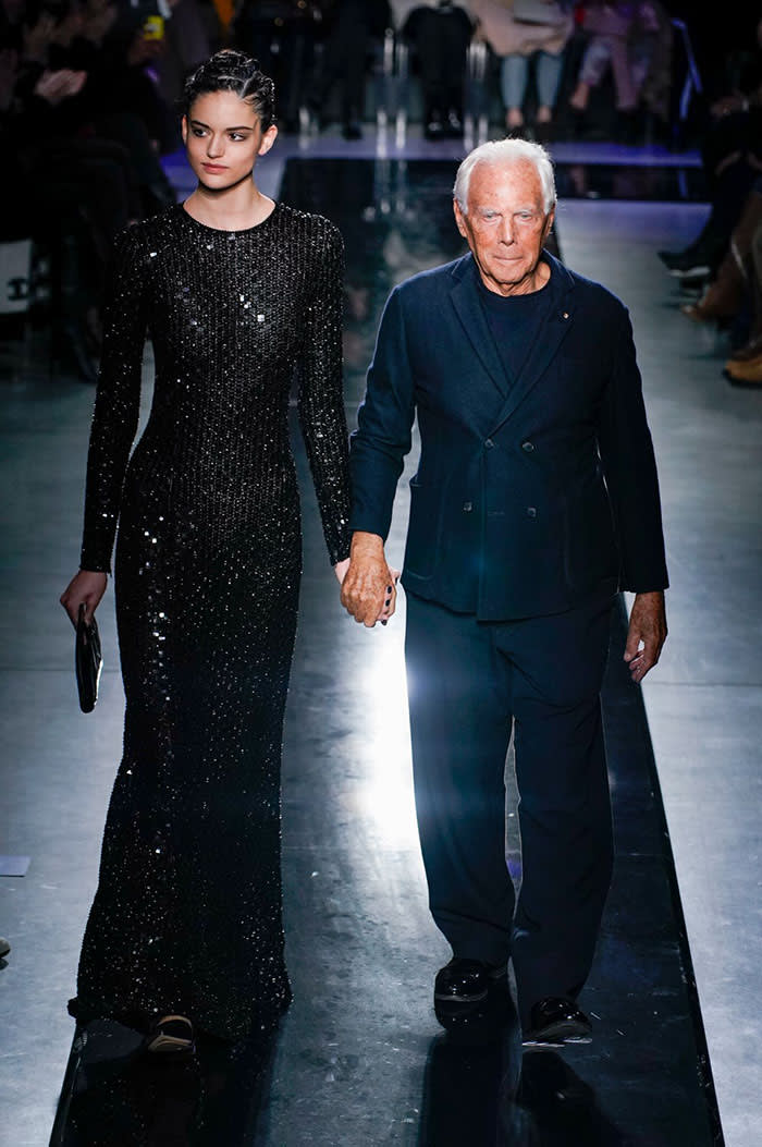 Designer Giorgio Armani appears with a model at his AW19 show