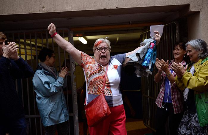 A woman celebrates outside a polling station after casting her vote in Barcelona, on October 01, 2017, in a referendum on independence for Catalonia banned by Madrid. Madrid has vowed to stop the referendum from going ahead, closing polling stations, seizing millions of ballot papers, detaining key organisers and shutting down websites promoting the vote. / AFP PHOTO / Josep LAGOJOSEP LAGO/AFP/Getty Images