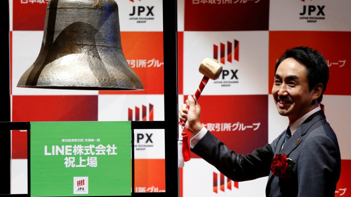 Line Corp. CEO Takeshi Idezawa poses before ringing a bell during a ceremony to mark the company's debut on the Tokyo Stock Exchange in Tokyo, Japan July 15, 2016.  REUTERS/Issei Kato     TPX IMAGES OF THE DAY     