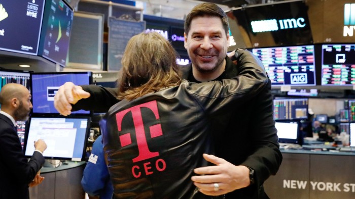 T-Mobile CEO John Legere and Sprint CEO Marcelo Claure (R) hug on the floor of the New York Stock Exchange in New York, NY, U.S., April 30, 2018. REUTERS/Brendan Mcdermid