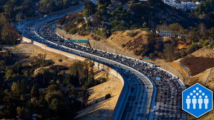 Vehicles sit in rush hour traffic on the Interstate 405 freeway through the Sepulveda pass in this aerial photograph taken over Los Angeles, California, U.S., on Friday, July 10, 2015. The greater Los Angeles region routinely tops the list for annual traffic statistics of metropolitan areas for such measures as total congestion delays and congestion delays per peak-period traveler. Photographer: Patrick T. Fallon/Bloomberg
