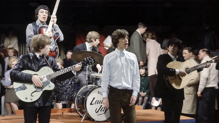 Left to right: Brian Jones (playing Gretsh guitar), Bill Wyman (back), Charlie Watts (back), Mick Jagger and Keith Richards, performing at Kingsway Studios, c1964