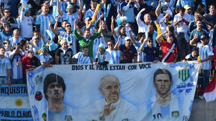 Fans of the Argentina national side display their reverence for Diego Maradona, Pope Francis and Lionel Messi