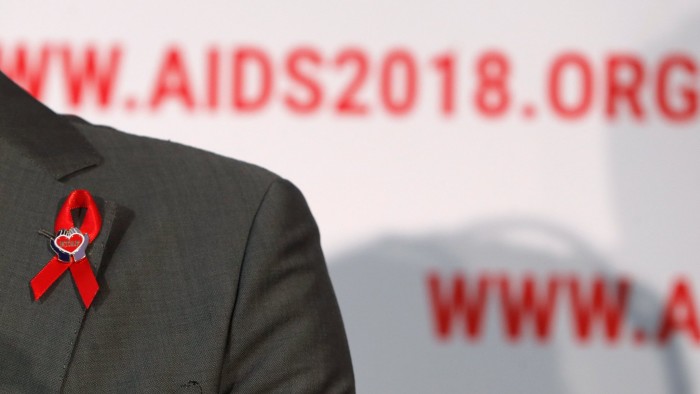 A red ribbon is seen on the jacket's lapel of Elizabeth Taylor AIDS foundation ambassador Quinn Tivey as he attends the opening news conference at the 22nd International AIDS Conference (AIDS 2018), the largest HIV/AIDS-focused meeting in the world, in Amsterdam, Netherlands, July 23, 2018. REUTERS/Yves Herman