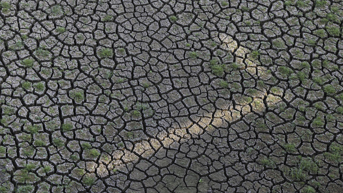 Cracked earth sits at the bottom of the dried-up Manjara Dam near Latur, Maharashtra, India, on Saturday, April 16, 2016. Hundreds of millions of people in India are grappling with one of the nation's worst droughts since independence, following two years of poor rainfall and the onset of intense summer heat. Photographer: Dhiraj Singh/Bloomberg