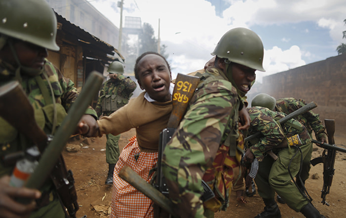 epa06297997 A police officer carries a school girl on his back to get her out of the scene after she was caught up in running battles with police and protesters and was affected by tear gas in Kawangware slum, Nairobi, Kenya, 30 October 2017. Kenya's education minister Fred Matiangi, who also serves as acting security minister, visited a school in Kawangware to inspect how the national exams are being conducted before he was heckled and stoned by supporters of the National Super Alliance (NASA) and its presidential candidate Raila Odinga. Tension is high in opposition strongholds of Nairobi as the country awaits for the electoral commission Independent Electoral and Boundaries Commission (IEBC) to declare President Uhuru Kenyatta the winner of the repeat presidential poll which was boycotted by Odinga. EPA/DAI KUROKAWA