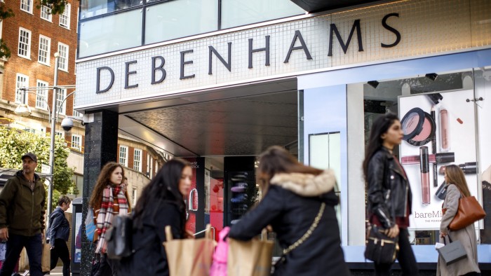 Shoppers walk past Debenhams store in Oxford Street, London on October 25, 2018.
