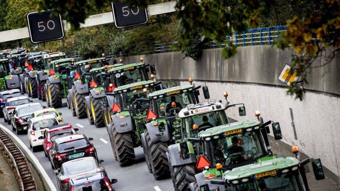 Farmers drive their tractors in a line in The Hague on October 16, 2019 during a protest against the nitrogen policy rules. (Photo by Koen van Weel / ANP / AFP) / Netherlands OUT (Photo by KOEN VAN WEEL/ANP/AFP via Getty Images)