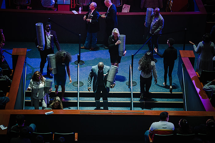 Church staff gather offering buckets – many congregants give a tenth of their income to Lakewood