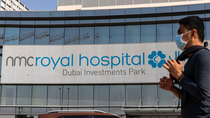 A pedestrian wearing a protective face mask passes the NMC Royal Hospital, operated by NMC Health Plc, in Dubai, United Arab Emirates, on Sunday, March 1, 2020. TroubledÂ NMCÂ Health Plc, the largest private health-care provider in the United Arab Emirates, asked lenders for an informal standstill on its debt as Dubai weighs an injection of capital to safeguard the emirates reputation among global investors. Photographer: Christopher Pike/Bloomberg via Getty Images