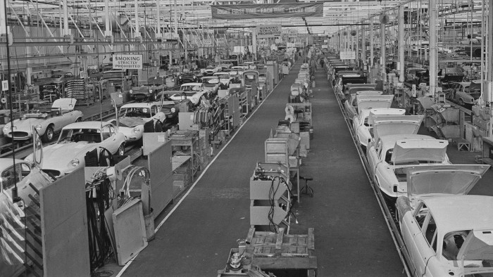 The Browns Lane plant of Jaguar Cars in Coventry, lies idle during power shortages brought about by the 1972 UK miners' strike, 14th February 1972. On the production line are Jaguar E-types and XJ6 models. A banner hanging from the ceiling (centre) reads: 'Right First Time-Each Time-Every Time'. (Photo by Ron Moran/Daily Express/Hulton Archive/Getty Images)