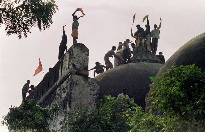 In this file photograph taken on December 6, 1992 Hindu youths clamour atop the 16th century Muslim Babri Mosque five hours before the structure was completely demolished by hundreds supporting Hindu fundamentalist activists. - An inquiry into the demolition of a mosque that led to bloody Hindu-Muslim riots in India will accuse senior Hindu nationalist politicians of orchestrating the destruction, a report said on November 23, 2009. The Bharatiya Janata Party (BJP) party stalled business in parliament over claims in the Indian Express newspaper that an official probe into the razing of the 16th-century Babri Mosque in 1992 &quot;indicted&quot; the party's leaders. AFP PHOTO/DOUGLAS E CURRAN/FILES (Photo credit should read DOUGLAS E. CURRAN/AFP/Getty Images)