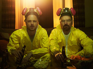 Bryan Cranston as Walter White with Aaron Paul as Jesse Pinkman, dressed in yellow overalls 