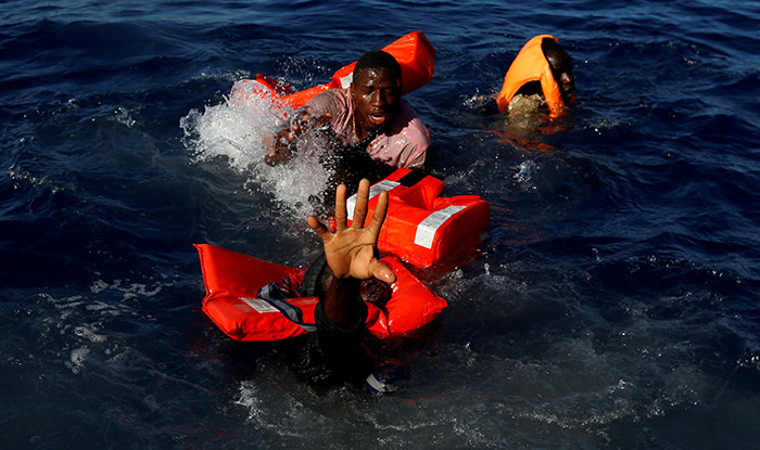 Migrants try to stay afloat after falling off their rubber dinghy during a rescue operation by the Malta-based NGO Migrant Offshore Aid Station (MOAS) ship in the central Mediterranean in international waters some 15 nautical miles off the coast of Zawiya in Libya, April 14, 2017. All 134 sub-Saharan migrants survived and were rescued by MOAS. Darrin Zammit Lupi: &quot;I spent five weeks with the Migrant Offshore Aid Station (MOAS) on their ship, Phoenix, covering search and rescue operations in the Mediterranean. At the start of the Easter weekend we were on a routine rescue around 15 nautical miles off the Libyan coast. I was on the MOAS fast rubber boat with crew members handing out life jackets to a group of 134 Sub-Saharan migrants on a flimsy dinghy before we would transfer them to the Phoenix. I had one camera up to my eye to shoot some wide angle frames. Suddenly, one migrant balancing on the rim of a dinghy slipped sideways and like dominos several of his colleagues lost their balance and fell into the sea. I captured the whole sequence by keeping my finger on the shutter button. It was chaos. I kept shooting as the rescuers leapt into action, helping several of the migrants pull themselves onto our boat. I was grabbing hold of people with one hand and shooting with the other. Then, through my viewfinder, a few metres away, I noticed one man struggling more than the others, stretching out his arm towards us. I screamed to alert our specialist rescue swimmer that one man was going under. He reacted instantly, jumped in, and pulled the man to safety. Afterwards, I did a lot of soul searching. Should I have put down my cameras altogether and just grabbed hold of whoever I could? That evening I discussed it with the rescuers, who felt I'd done the right thing. Their job was to rescue lives. Mine was to document the harsh reality of what's happening. Everyone survived that day.&quot; REUTERS/Darrin Zammit Lupi/File photo SEARCH &quot;POY STORY&quot; FOR THIS STORY.