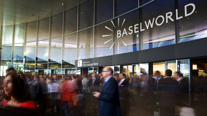 Baselworld Annual Watch Fair 2013...Visitors enter and exit the main entrance during the Baselworld watch fair in Basel, Switzerland, on Thursday, April 25, 2013. The annual fair attracts 2,000 companies from the watch, jewelry and gem industries to show their new wares to more than 100,000 visitors. Photographer: Gianluca Colla/Bloomberg