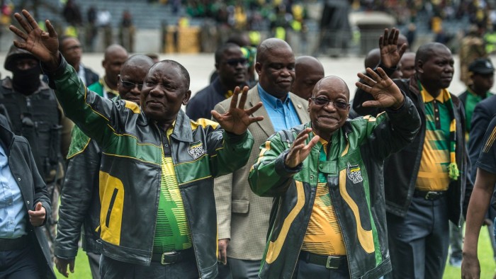 South African President Jacob Zuma (R) and South African ruling party African National Congress (ANC) deputy president Cyril Ramaphosa (L) gesture as they arrive at Orlando Stadium in Soweto on January 8, 2017 for a ceremony marking the 105th ANC's anniversary. South African President Jacob Zuma on January 8, 2017 denounced corruption within the ruling ANC party and admitted that mistakes had cost the party at the ballot box after a year of damaging scandals. / AFP / MUJAHID SAFODIEN (Photo credit should read MUJAHID SAFODIEN/AFP/Getty Images)