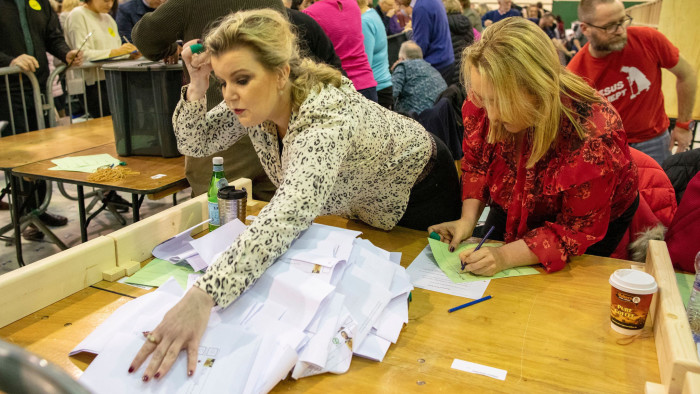 The count gets under way at Nemo Rangers GAA club in Cork, southern Ireland, on February 9, 2020, the day after the vote took place in the Irish General Election. - Irish officials started tallying votes on Sunday in a general election forecast to put prime minister Leo Varadkar's party in a historic three-way tie, after a surge from republican party Sinn Fein. Counting began at 0900 GMT after an exit poll predicted Varadkar's Fine Gael party, the Fianna Fail party and Sinn Fein all received 22 per cent of first preference votes in Saturday's election. (Photo by Paul Faith / AFP) (Photo by PAUL FAITH/AFP via Getty Images)