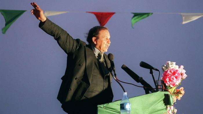Algerian presidential candidate Abdelaziz Bouteflika, nominally independent but backed by Algeria's former sole ruling party, the National Liberation Front, addresses supporters in Adrar, some 1,400 kms south of Algiers, late 09 April 1999. Algerians will go to the polls 15 April 1999 in an early election to elect a new president to succeed outgoing president Liamine Zeroual who stepped down last September, 19 months before the end of his five-year term. (Photo by MANOOCHER DEGHATI / AFP) (Photo credit should read MANOOCHER DEGHATI/AFP/Getty Images)