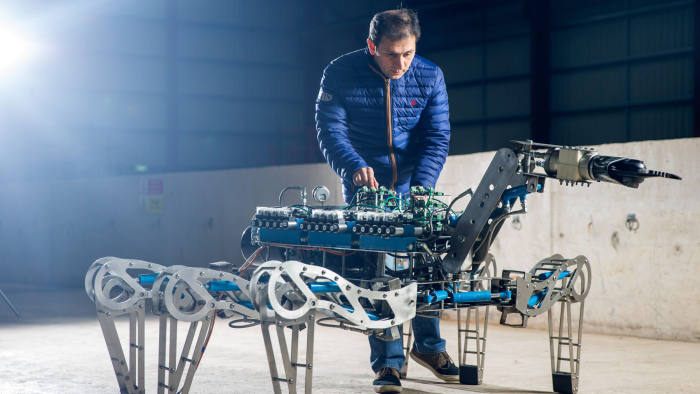 Farshad Arvin, research associate at the University of Manchester, demonstrates the LATRO, a hydraulically powered robotic spider equipped with grippers and cutting tools, designed to monitor and gather information in a nuclear environment, at Forth Engineering Ltd. in Maryport, U.K., on Tuesday, Dec. 20, 2016. Sellafield, the 70-year-old home to Europe's largest nuclear site with 10,000 employees and its own rail service and police and fire departments looks its age and will eventually cost at least £90 billion to properly clean up, says Paul Dorfman, honorary senior researcher at the Energy Institute at University College London. Photographer: Matthew Lloyd/Bloomberg