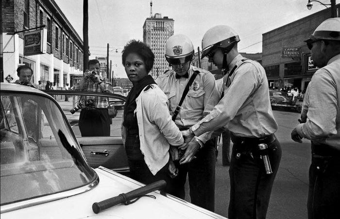 September 7, 1963, Birmingham, Alabama, USA: From a collection of previously unknown photographs documenting the civil rights movement, found at the offices of the Birmingham News. Police arrest Parker High School student Mattie Howard on day 6 of a children's civil rights campaign.///Police arrest Mattie Howard (C) before photographers.. Credit: Dean / Birmingham News / Polaris / eyevine For further information please contact eyevine tel: +44 (0) 20 8709 8709 e-mail: info@eyevine.com www.eyevine.com