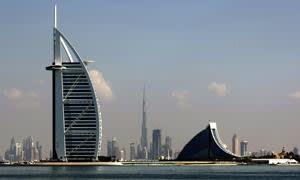 Dubai's three most prominent architectural icons, Burj an-Arab Hotel (L), Jumirah Hotel (R) and Burj Dubai (C), are seen along the coast of Dubai, on December 21, 2009. Dubai's heavily-indebted group, Dubai World, began talks with its lenders over its request to restructure 22 billion dollars in debt but has made no specific proposals, a company spokesman said. AFP PHOTO/MARWAN NAAMANI (Photo credit should read MARWAN NAAMANI/AFP/Getty Images)