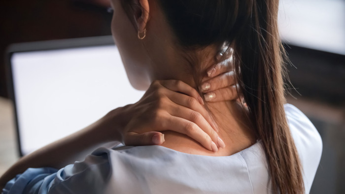 Tired woman massaging rubbing stiff sore neck tensed muscles fatigued from computer work in incorrect posture feeling hurt joint shoulder back pain ache, fibromyalgia concept, close up rear view; Shutterstock ID 1492613306; Department: -; Job/Project: -; Employee Name: -