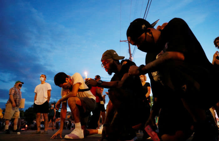 A man holds a candle as he reacts at the scene of the death, in Minneapolis police custody, of George Floyd in Minneapolis, Minnesota, U.S., June 3, 2020. REUTERS/Lucas Jackson