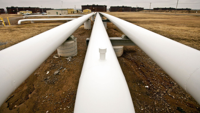 Oil pipelines run near storage tanks at the Enbridge Inc. Cushing Terminal in Cushing, Oklahoma, U.S., on Friday Feb. 24, 2011. Oil in New York surged to a 29-month high of $103.41 a barrel on Feb. 24 as Libyan leader Muammar Qaddafi vowed to crush an uprising that threatens his 42-year rule. Photographer: Shane Bevel/Bloomberg
