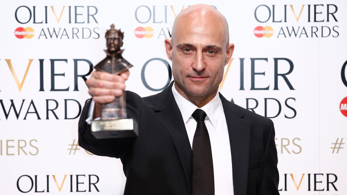 Mark Strong poses with the best actor award for his work in 'A View from the Bridge' at the Lawrence Olivier Awards at the Royal Opera House