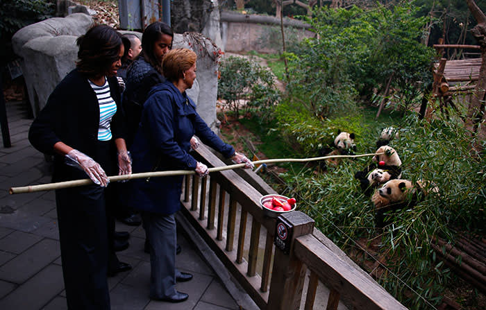 Michelle Obama with her mother and daughters feeding pandas in Chengdu, Sichuan province, 2014